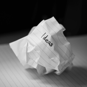 Crumpled up lined paper with the word ‘ideas’ written