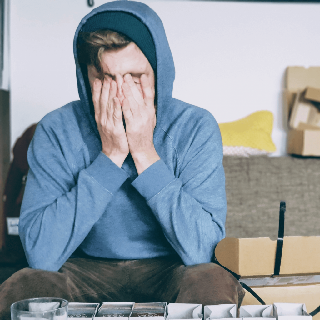 Man covering face with both hands