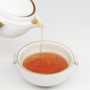 Lemongrass tea pouring into a teacup