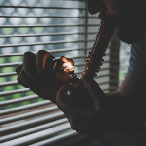 A man taking a bong rip