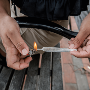 A person lighting a joint
