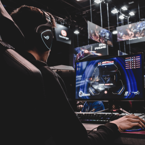 A person sitting on a gaming chair and playing video games