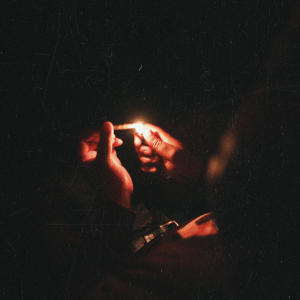 a person lighting a blunt