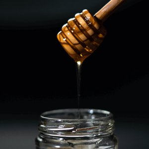 THC honey dripping into a jar