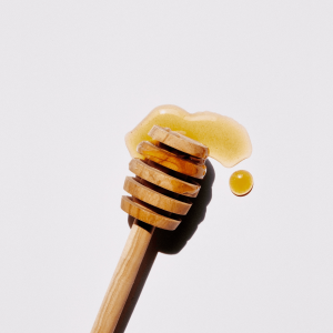 a brown wooden stick with honey