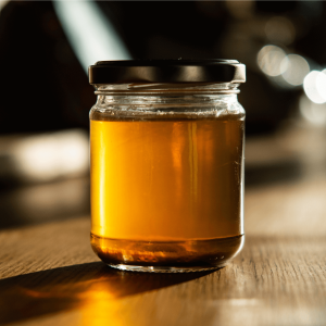 a jar of honey sitting on a table