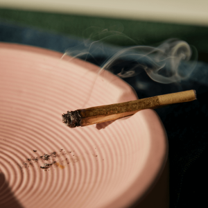 a joint burning over an ashtray 