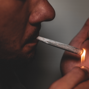 a man lighting a joint