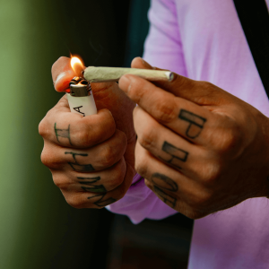 A man lighting a joint