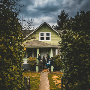 Friends gathered on a porch smoking weed