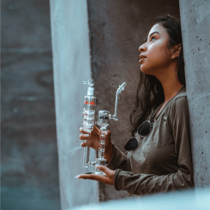 a woman holding a dab rig