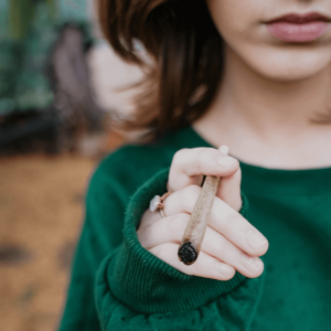 A girl smoking a large joint