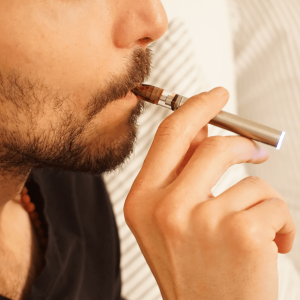 a man smoking a cannabis vape