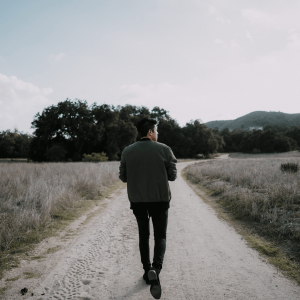 Man walking on an empty park walking trail