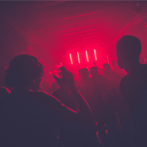 people partying inside a red-lit room