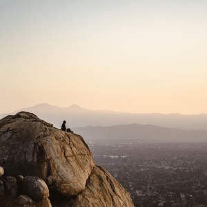 person standing on a rock overlooking riverside, ca