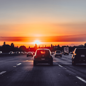 cars driving on a California highway at sunset