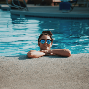 a woman smiling in a swimming pool