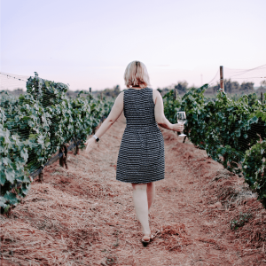 a woman taking a vineyard tour
