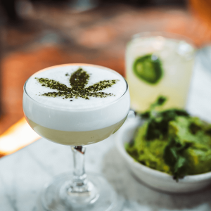 handcrafted cocktail glass with cannabis leaf on top