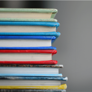 a stack of blue and yellow hardcover books