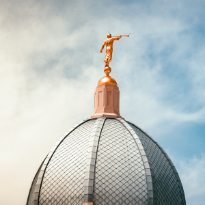 Gold statue on top of a steeple 