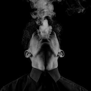 a man blowing smoke