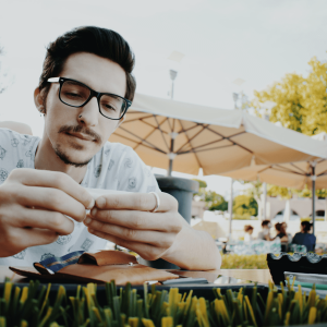 A man rolling a joint