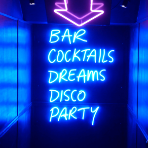 a neon sign reading bar cocktails dreams disco party