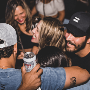 a group of people smiling and drinking