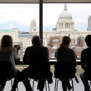 People sitting and talking overlooking a cityscape 