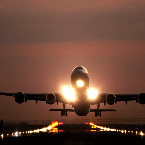 a plane taking off at night on a runway