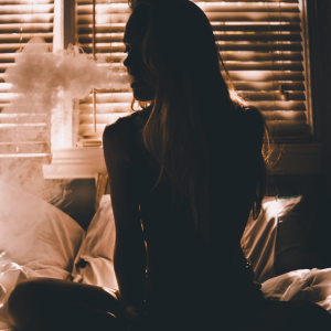 a woman smoking in bed