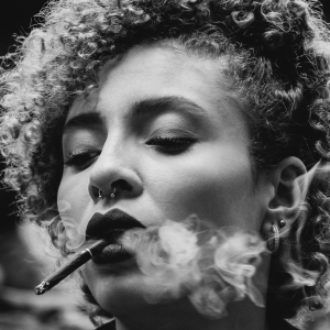 black and white image of a woman smoking