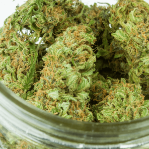 green weed nugs in an open glass jar