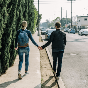 a couple holding hands and walking in Glendale California 