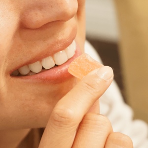 a person consuming an edible gummy