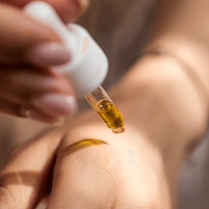 a person applying topical cannabis oil