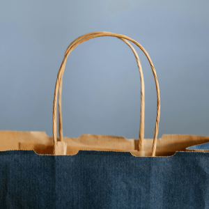 a dark blue shopping bag against a blue background