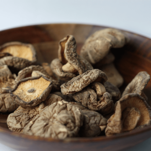 a brown bowl filled with dried mushrooms