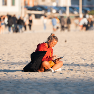 a girl reading on the beach in Santa Monica California
