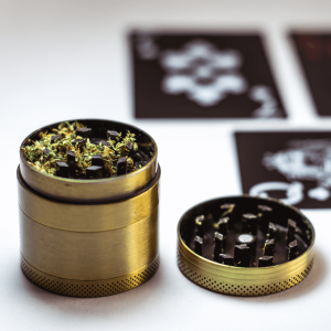 green herb in a gold grinder