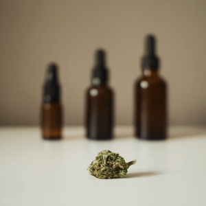 a cannabis nug with three amber bottles blurred in the background