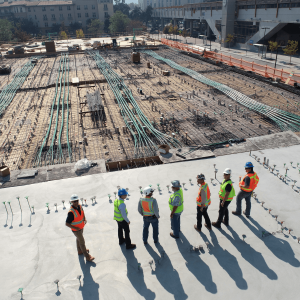 seven construction workers overlooking a construction site