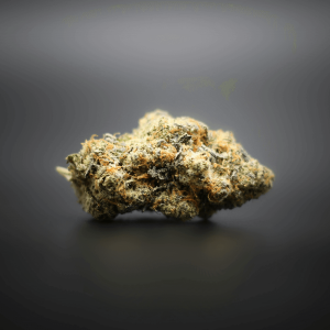 a fluffy green cannabis nug against a gray background