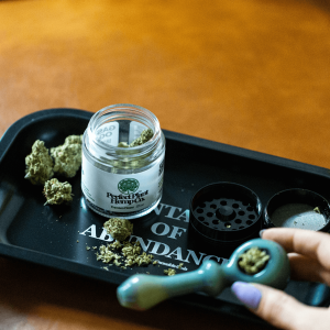a rolling tray with a bowl and jar of hemp flower