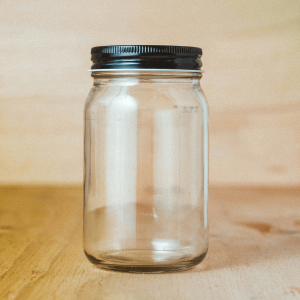 a clear mason jar with a black lid
