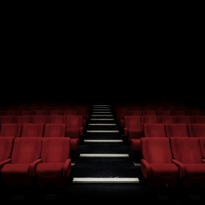 an empty theater with red seats