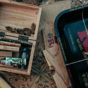 cannabis accessories including joints and flower next to a rolling tray