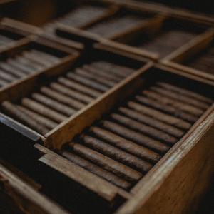 brown cigars in a wooden container